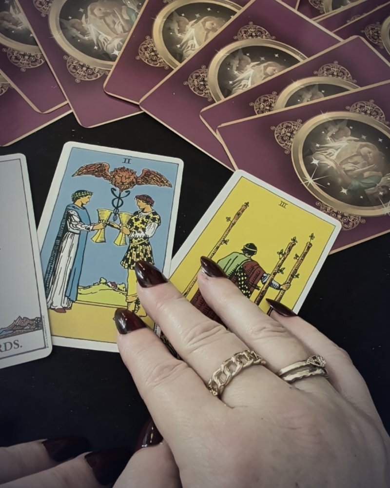 Hand resting on the Two of Cups